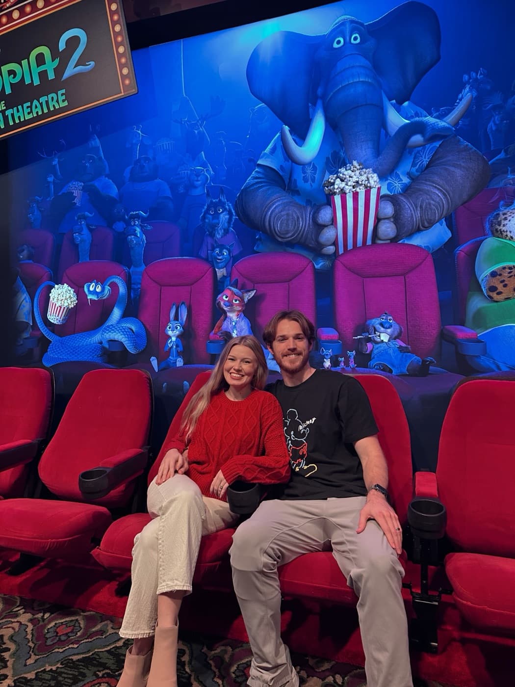 Kayla and her husband in the El Capitan Theatre seats before Zootopia 2